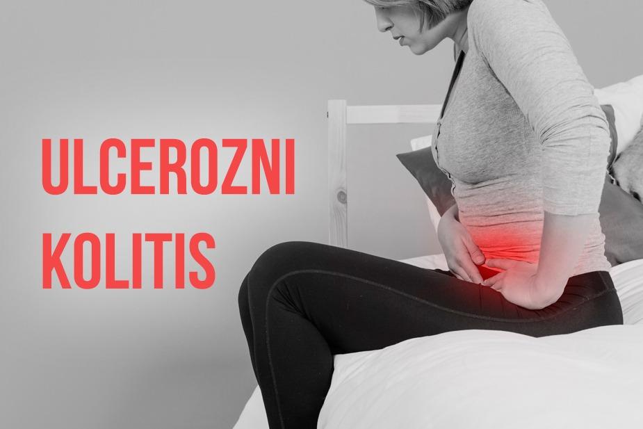 Žena sedi na krevetu i drži se za stomak